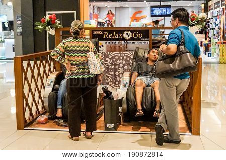 Kota Kinabalu,Sabah-May 29,2017:People relaxing in massage chair at Imago the shopping centre Kota Kinabalu,Sabah,Borneo,Malaysia.