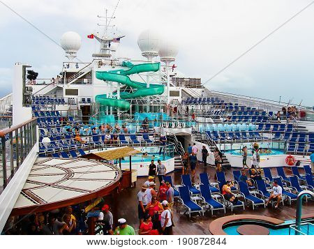 Miami, United States of America - January 5, 2014: The people resting at Carnival Glory Cruise Ship, the ship leaving Miami, USA on January 5, 2014. Carnival Glory is a Conquest-class cruise ship built in 2003 with capacity of 2974 passengers