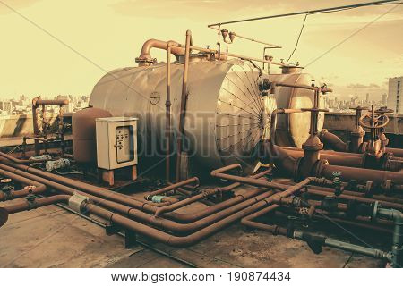Vintage Retro Industrial Machine Old Grunge Rusty Pipe And Boiler Tank.