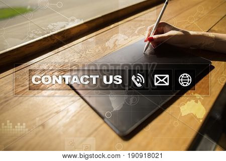 Contact us button and text on virtual screen. Business and technology concept.