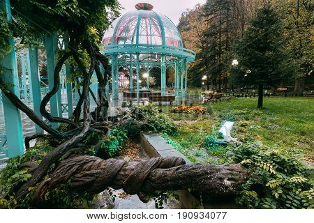 Borjomi, Samtskhe-Javakheti, Georgia. Pavilion Above Hot Spring Of Borjomi Mineral Water. Famous Local Landmark Is City Park At Autumn October Evening.