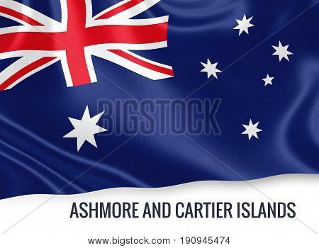 Australian state Ashmore and Cartier Islands flag waving on an isolated white background. State name is included below the flag. 3D rendering.