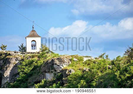 Wonderful landscape with rocks and mountains at orheiul vechi monastery and memorial in moldova, near raut river, blue sky, sunny day, bell tower