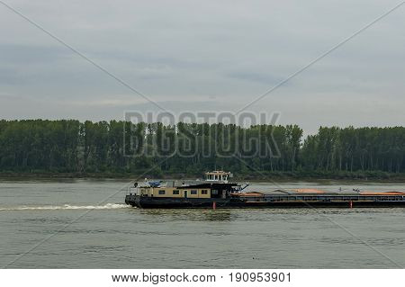 Pass  tug-boat  in the river Danube along Vidin port, Bulgaria, Europe