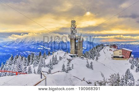 Panoramic landscape from top of Postavaru mountain Bucegi mountain in background Poiana Brasov Romania.