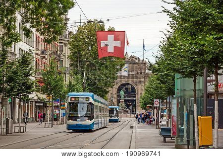 Zurich Shopping Street Bahnhofstrasse With Tram And Swiss Flag