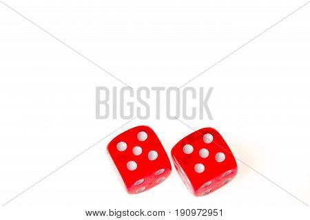 Two red dice both showing a five on the upper faceisolated against a white background
