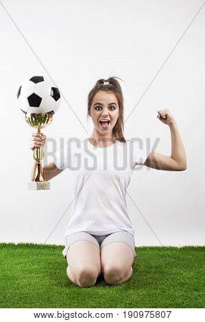 Happy soccer player celebrating goal on a soccer field. White background