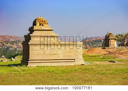 View of ancient ruins on Hemakuta hill in Hampi, Karnataka, India. Landscape with unique mountain formation with amazing stones tropical nature and temple. UNESCO World Heritage Site