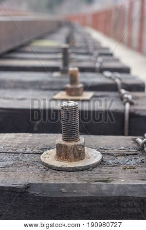 close up shot of bolts and nut for fastening of cross ties of the railroad