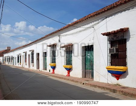 A street in Mompox with windows painted in the colours of the Colombian flag