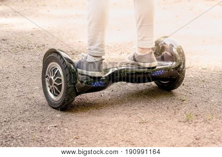 Moscow, Russia, June 7 2017: Girl feet on the hover board.This modern gadget is also known as hoverboard, gyroscooter, mini scooter