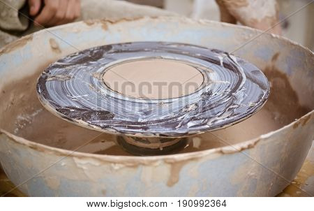 An empty circle, where the potter molds product close-up. Creative studio potter. Workplace wizard Crock pottery