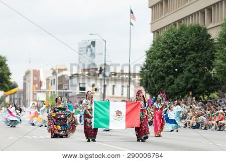 Indianapolis, Indiana, USA - May 26, 2018, Members of the Mexican themed dancing group, Ballet Folklorico Mosaicos, perform at the Indy 500 Parade