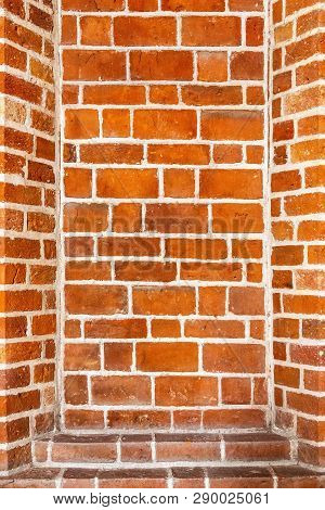 Recess Arch Frame In Old Brick Wall. Detail Of Decorative Portal In A Red Brick Wall. Recess In A Br