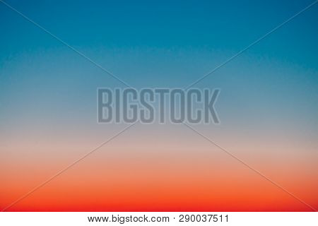 Predawn Clear Sky With Red Horizon And Blue Atmosphere. Smooth Orange Blue Gradient Of Dawn Sky. Bac