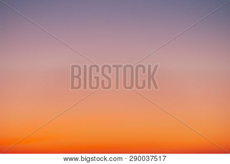 Predawn Clear Sky With Orange Horizon And Violet Atmosphere. Smooth Orange Violet Gradient Of Dawn S