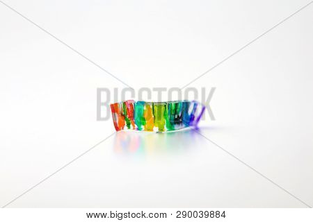 Colorful eye catching hand painted plastic abstract artwork, on neutral white background with natural shadows.
for cover of something involving colors and shapes.