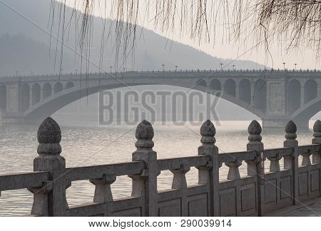 The Walk Way Along And The Bridge With The Chinese Style At The Longmen Grottoes. The Longmen Grotto