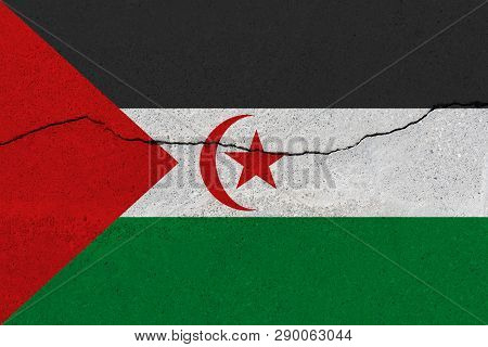 Sahrawi Arab Democratic Republic Flag On Concrete Wall With Crack. Patriotic Grunge Background. Nati