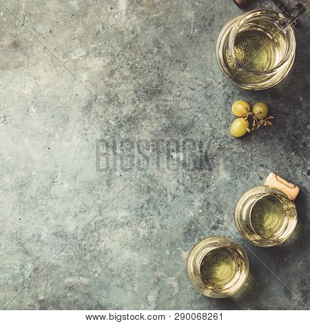 Glasses of white sparkling wine on rustick background