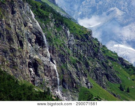 Waterfall Milchbachfall Or Wasserfall Milchbachfäll, Milchbäch Stream In The Alpine Valley Of Madera