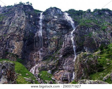 Waterfall Milchbachfall Or Wasserfall Milchbachfäll, Milchbäch Stream In The Alpine Valley Of Madera