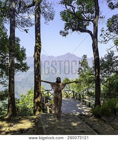 Women Raise Their Arms Background Trees And Mountains At Nern Chang Puak View Point , Kanchanaburi, 