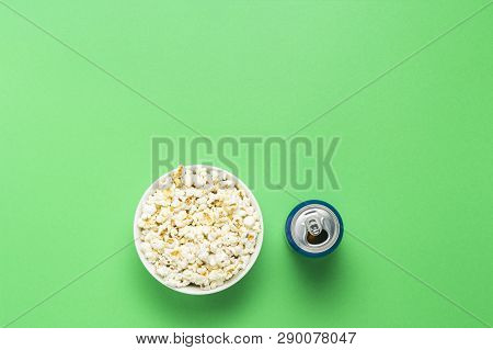 Bowl With Popcorn And A Can Of Drink On A Green Background. The Concept Of Watching Movies And Favor