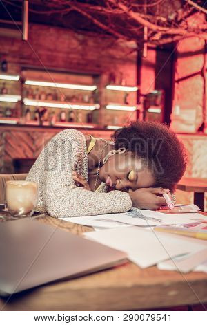 Overweary Afro-american Fashion Creator Sleeping Over Cafeteria Table