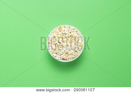 Bowl With Popcorn On A Green Background. Flat Lay, Top View.