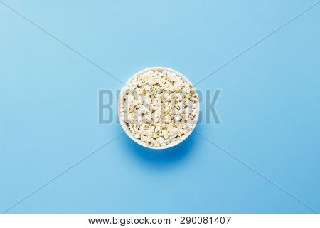 Bowl With Popcorn On A Blue Background. Flat Lay, Top View.