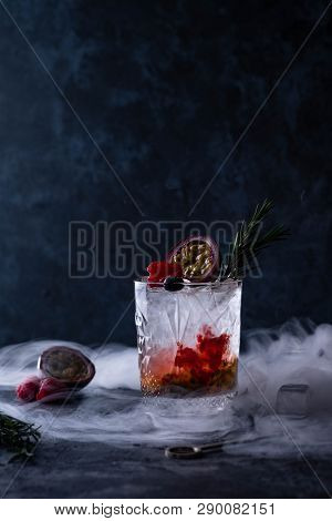 Refreshing With A Glass Of Passion Fruit Cocktail On Black Background.