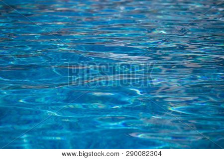 Blurred Water Texture In Summer Pool Close Up.