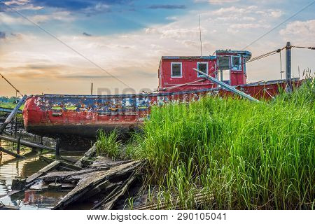 An Abandoned Old Boat Along The Shoreline In Middletown Along The Jersey Shore.