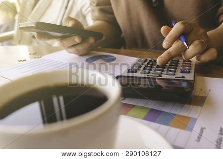 Business Woman Calculating Finance Data At Office.