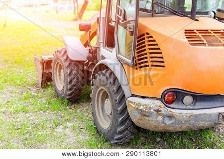 Wheel Loader Machine On Grass Field In Park Area. Municipal Works On Reconstruction And Renewal City