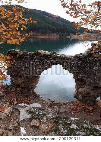 Lake With Mountains Around And Stone Decor