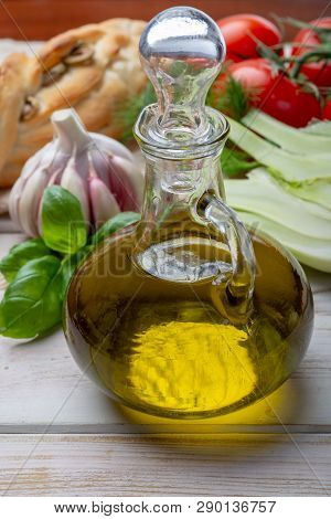 Virgin Natural Olive Oil Is Glass Bottle, Served With Traditional Mediterranean Food