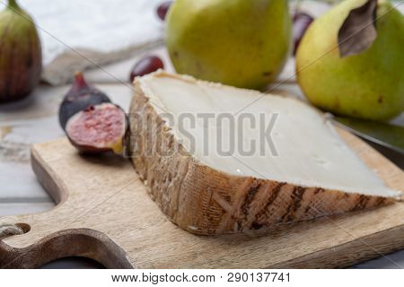 Piece Of French Cheese Tomme De Brebis Made From Sheep Milk Served As Dessert With Fresh Figs And Pe