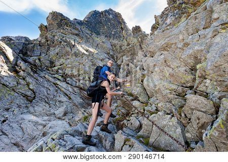 Tourists Trekking In Beautiful Mlynicka Dolina On The Way To Bystre Sedlo - In Slovakian High Tatra 