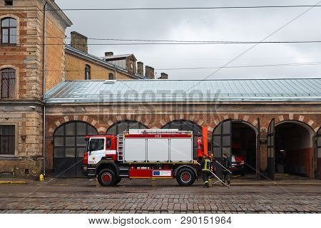 Riga, Latvia - March 16, 2019: Fire Truck Is Being Cleaned - Driver Washes Firefighter Truck At A De