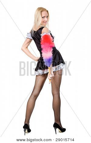 beautiful blonde in a dress of the parlourmaid and with a whisk in hands. Isolated on white