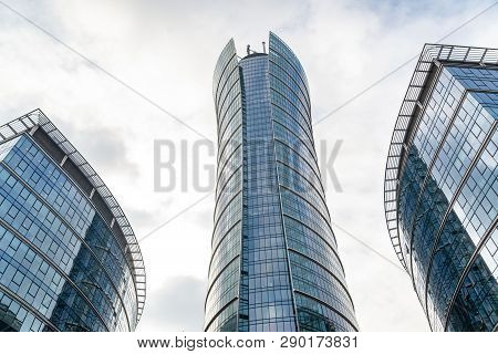 Glass Skyscrapers Of Irregular Shape. Bottom View. Abstract Architectural Detail Of Corporate Buildi
