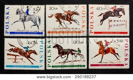 Fort Collins, CO, USA - March 10, 2019: Equestrian sports on a set of vintage canceled post stamps from Poland (1967).