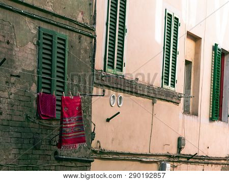 Siena,tuscany/italy 23 February 2019 :carpet In The Alley Outside Of House Window