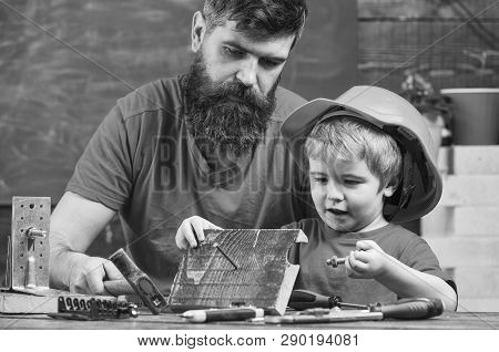 Father, Parent With Beard Teaching Little Son To Use Hobnails And Hammer. Masculine Duties Concept. 