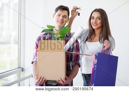 Nnew A Apartment. Happy Couple In Their New Home. Young Couple Hugging Indoors