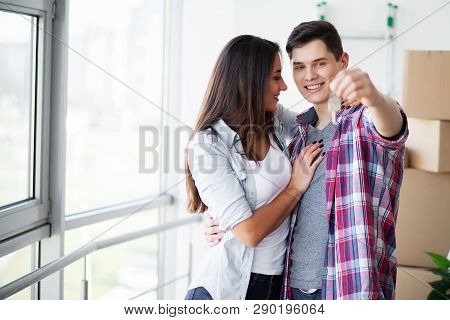 Nnew A Apartment. Happy Couple In Their New Home. Young Couple Hugging Indoors