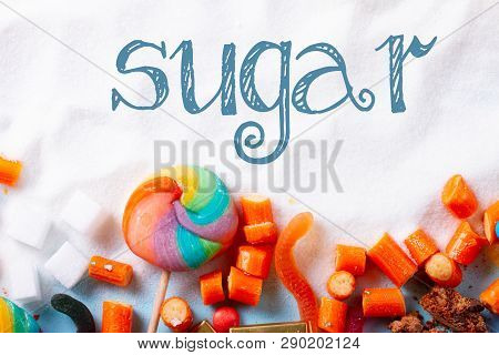 Sweets And Candies With Sugar, Flat Lay With Word Sugar